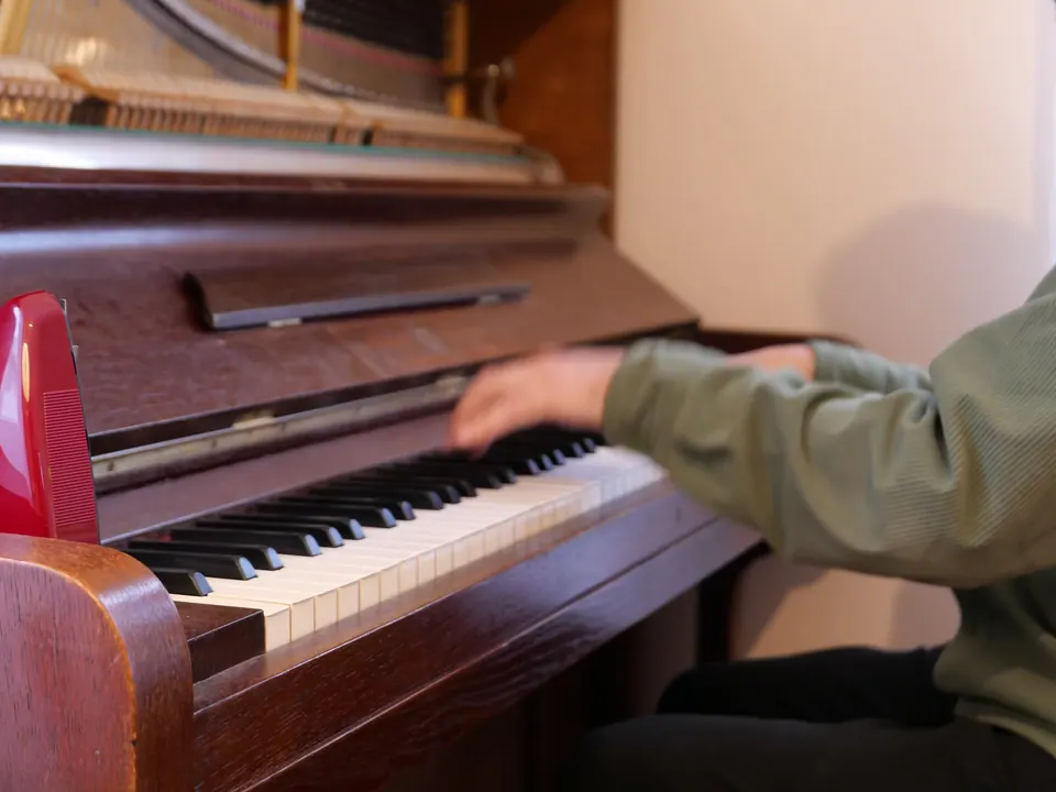 Close-up of the keys and open mechanism of the 100-year-old upright piano